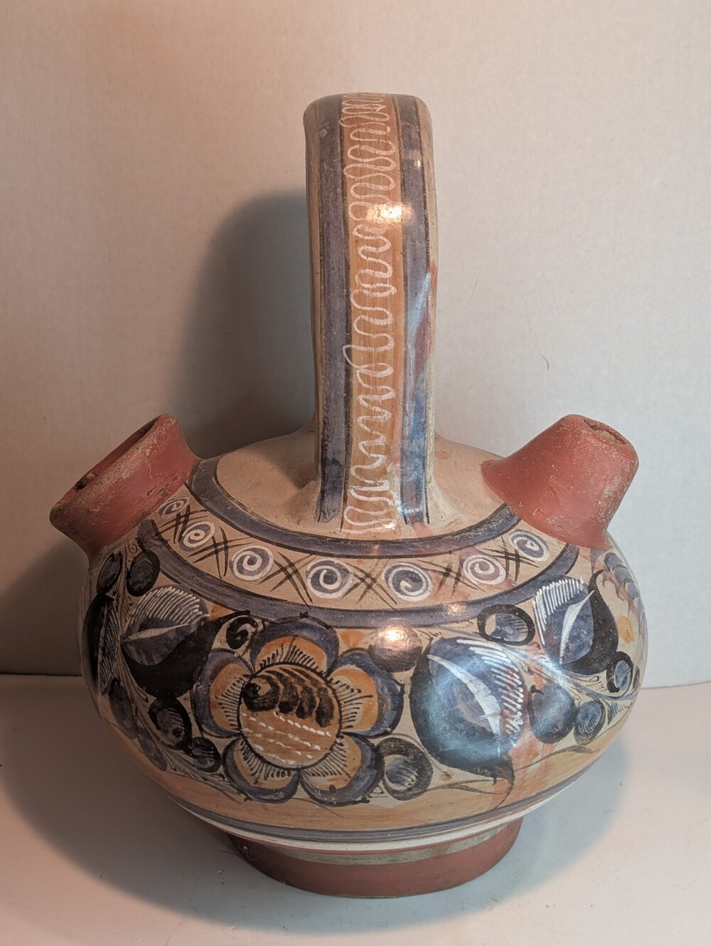 A vintage Mexican Tonalá burnished pottery double-spout water jug.